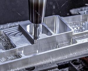 3-axis CNC milling machine machining a metal component with a rotating end mill